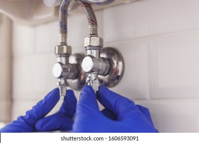 Plumber Closing Angle Valves Of Hot And Cold Water Supply Under The Washbasin For Service Hoses Or Replace Tap.