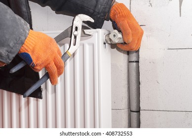 plumber to connect the heating radiator to a polypropylene pipe - Shutterstock ID 408732553