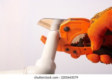 A Plumber Cuts Off A Polypropylene Pipe.