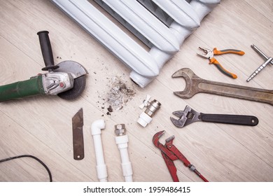 Plumber Different Tools, Angle Grinder And Equipment For Repair Valve Of Broken Radiator Central Heating And Pipes At Home