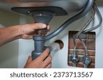 plumber disassembles the siphon under the sink,repair of plumbing in the kitchen, pipes clogged with dirt residues