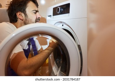 A Plumber Or Plumber From The Emergency Repair Service Repairs A Tumble Dryer