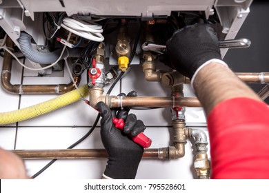 Plumber Fixing Central Heating System