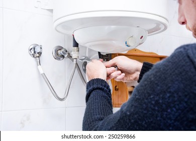 Plumber Fixing Electric Water Heater