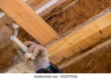 Plumber Gluing Cement CPVC Plastic Water Line White Pipe On Of New House Soft Focus