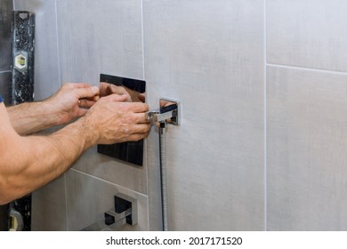 Plumber Hands Fixing Shower Mixer On Modern Tap In Bath Control Heat