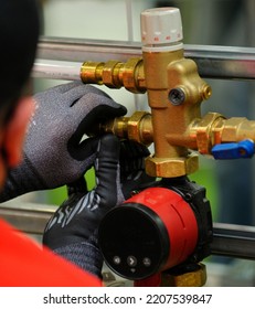 Plumber Hands Installing Circulation Pump For Heating System.