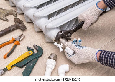 Plumber Hands Repairing Valve Of Broken Radiator Central Heating With Spanner