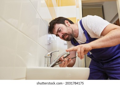 Plumber Handyman Repairs Broken Faucet On Bathroom Sink