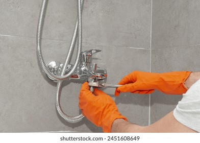 Plumber installing shower hose in a bathroom - Powered by Shutterstock