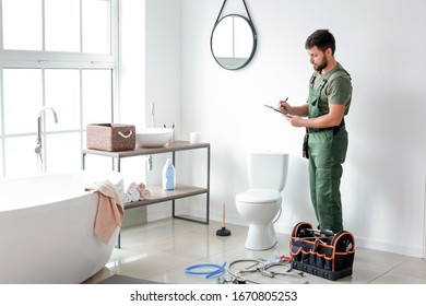 Plumber Installing Toilet Bowl In Bathroom