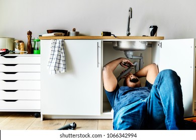 Plumber Man Fixing Kitchen Sink