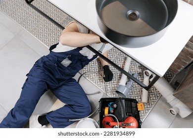 Plumber man at work in bathroom, fix repair service with pipe of sewage, top view. Concept install plumbing. - Shutterstock ID 2281934899