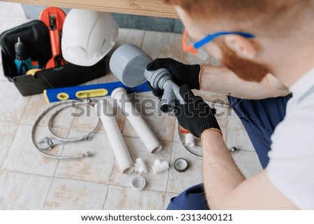 Plumber man at work in bathroom, fix repair service. Concept assemble and install plumbing.