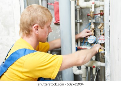 Plumber Man Worker With Spanner Installing Water Meter