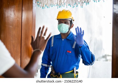 Plumber With Medical Face Mask Greeting Customer At Home Service - Concept Of Home Plumbing Repair And Maintenance Service With Covid-19 Or Coronavirus Safety Measures During Pandemic.
