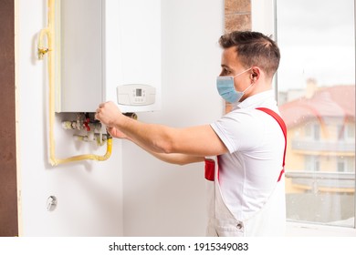 The Plumber In A Medical Mask Works During A Pandemic