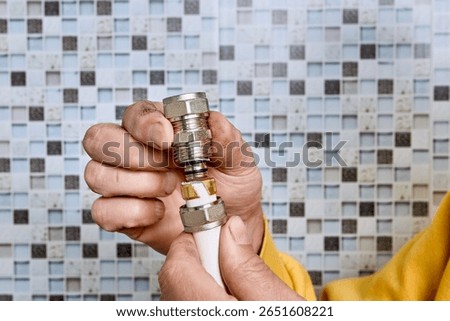 Plumber places compression ring on multilayer pipe for connecting it with second pipe using coupling during repair of household water line.