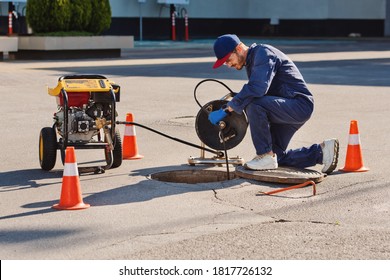 Plumber Prepares To Fix The Problem In The Sewer. Repair Work On Troubleshooting.