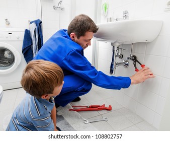 a plumber repairing a broken sink in bathroom
