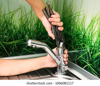 Plumber Repairing The Faucet Of A Sink In Kitchen, Man Repair And Fixing Leaky Old Faucet, Cartridge Or Mixer Of The Faucet, Concept Of Repair And Technical Assistance