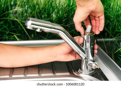 Plumber Repairing The Faucet Of A Sink In Kitchen, Man Repair And Fixing Leaky Old Faucet, Cartridge Or Mixer Of The Faucet, Concept Of Repair And Technical Assistance