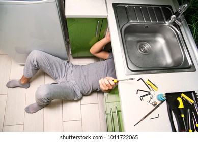 Plumber Repairing The Faucet Of A Sink In Kitchen, Man Repair And Fixing Leaky Old Faucet, Cartridge Or Mixer Of The Faucet, Concept Of Repair And Technical Assistance, Top View, Kitchen Overview