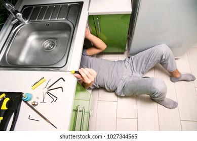 Plumber Repairing The Faucet Of A Sink In Kitchen, Man Repair And Fixing Leaky Old Faucet, Cartridge Or Mixer Of The Faucet, Concept Of Repair And Technical Assistance, Top View, Kitchen Overview