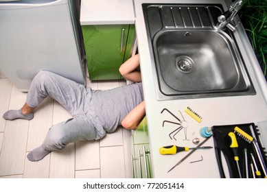 Plumber Repairing The Faucet Of A Sink In Kitchen, Man Repair And Fixing Leaky Old Faucet, Cartridge Or Mixer Of The Faucet, Concept Of Repair And Technical Assistance, Top View, Kitchen Overview