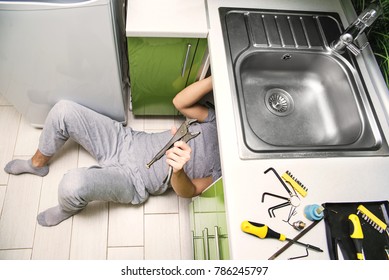 Plumber Repairing The Faucet Of A Sink In Kitchen, Man Repair And Fixing Leaky Old Faucet, Cartridge Or Mixer Of The Faucet, Concept Of Repair And Technical Assistance, Top View, Kitchen Overview