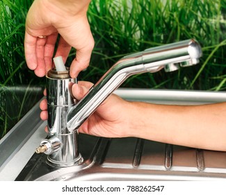 Plumber Repairing The Faucet Of A Sink In Kitchen, Man Repair And Fixing Leaky Old Faucet, Cartridge Or Mixer Of The Faucet, Concept Of Repair And Technical Assistance