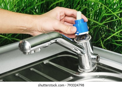 Plumber Repairing The Faucet Of A Sink In Kitchen, Man Repair And Fixing Leaky Old Faucet, Cartridge Or Mixer Of The Faucet, Concept Of Repair And Technical Assistance