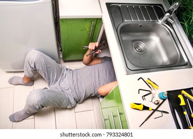 Plumber Repairing The Faucet Of A Sink In Kitchen, Man Repair And Fixing Leaky Old Faucet, Cartridge Or Mixer Of The Faucet, Concept Of Repair And Technical Assistance, Top View, Kitchen Overview