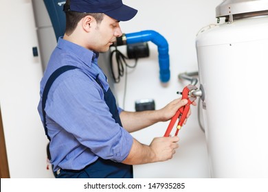 Plumber Repairing A Hot Water Heater 