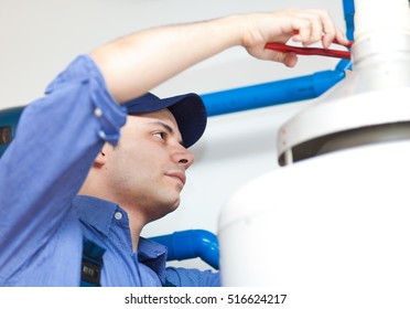 Plumber repairing an hot-water heater 