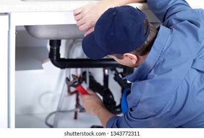 plumber repairs a sink. - Shutterstock ID 1343772311