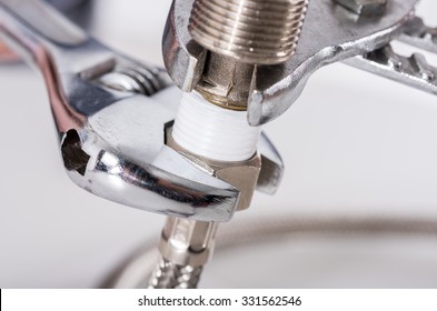 Plumber screwing plumbing fittings, closeup - Shutterstock ID 331562546