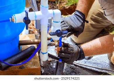 Plumber service assembles connection between water well house water system