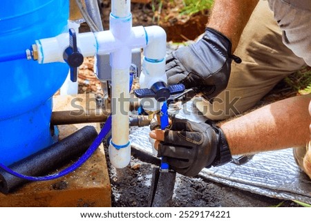 Plumber service assembles connection between water well house water system