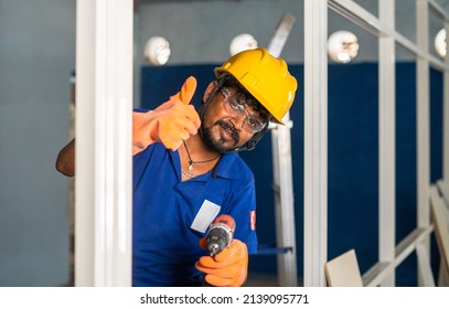 plumber showing thumbs up sign by holding drilling machine at construction site - concept of repair or maintenance service, expertise and blue collar job. - Powered by Shutterstock