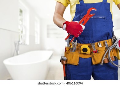 Plumber With Tool Belt Standing In Bathroom