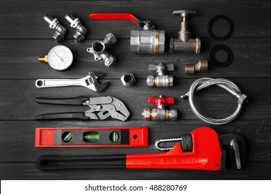 Plumber Tools On A Gray Wooden Background