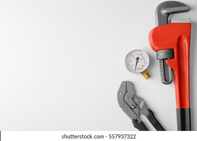 Plumber tools with red wrench isolated on white