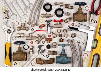 Plumber Tools And Spare Parts On White Wooden Background, Top View, Flat Lay 