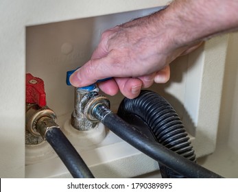 Plumber Turning Cold Water Supply Shut-off Valve For Clothes Washing Machine.