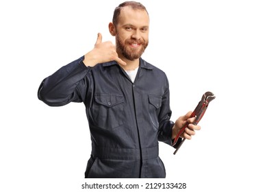 Plumber in a uniform holding pliers and gesturing call me sign isolated on white background