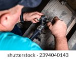 Plumber welding plastic pipes using welder machine.
