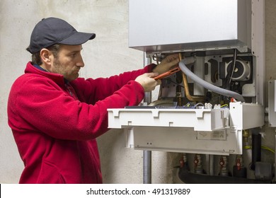 Plumber Who Carries Out The Maintenance Of A Condensing Boiler