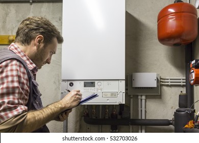 Plumber Who Carries Out The Maintenance Of A Condensing Boiler