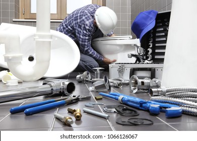 plumber at work in a bathroom, plumbing repair service, assemble and install concept